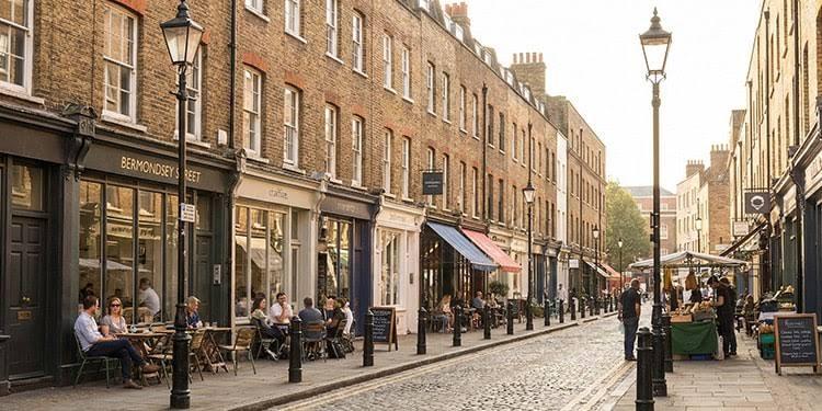 Georgian terraces and pavement cafe tables along Bermondsey Street, with the cobbled roadway running south.