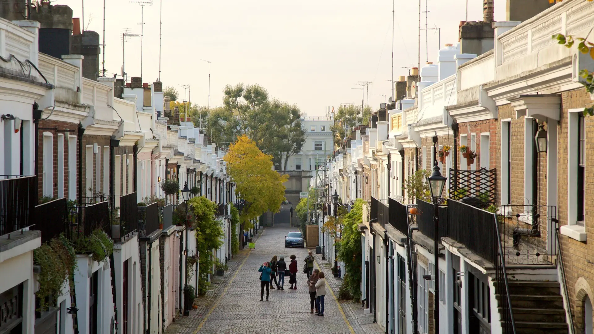 A narrow cobbled mews in Central London, lined with converted coach houses and too tight for a box van.